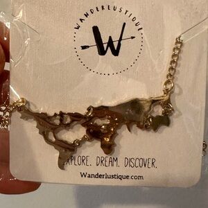 Wanderlustique Gold Colored World Map Necklace